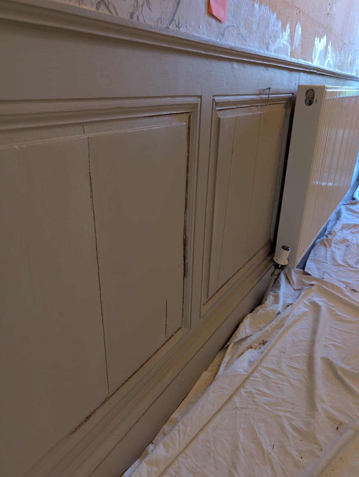 Designer wallpaper being hung in the entrance hall