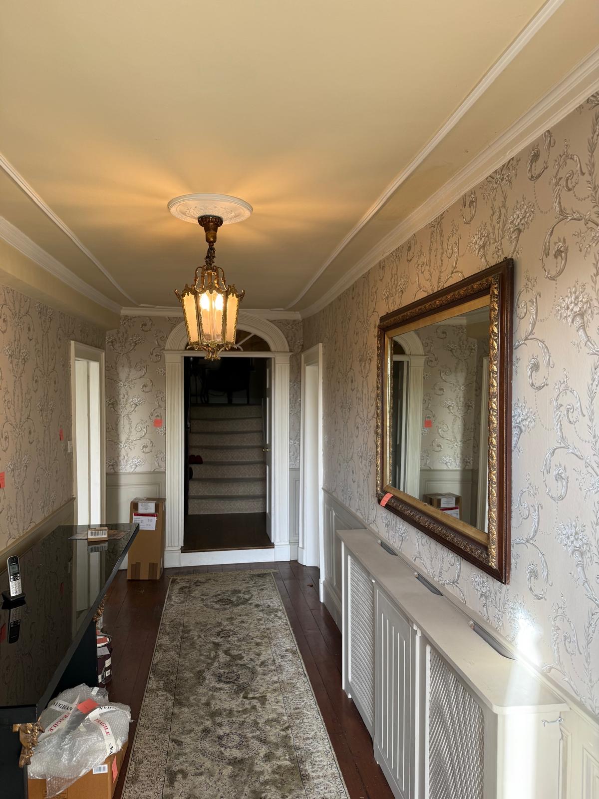 Stripping six layers of old wallpaper from hallway walls